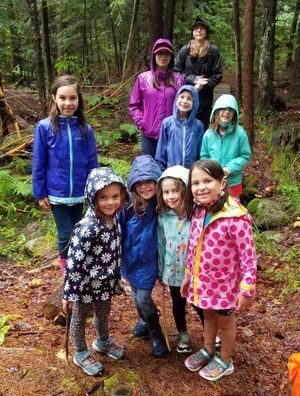 girls exploring nature in the rain