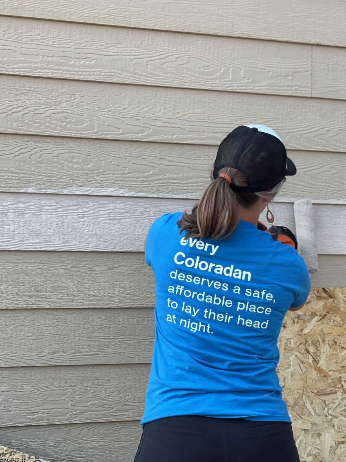 Habitat Colorado Build: Volunteer Painting outside of the garage