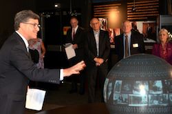 Jonathan Freed demonstrates using the Magic Planet at the NCM exhibit opening.