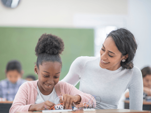 Student and teacher work together on building a small STEM model