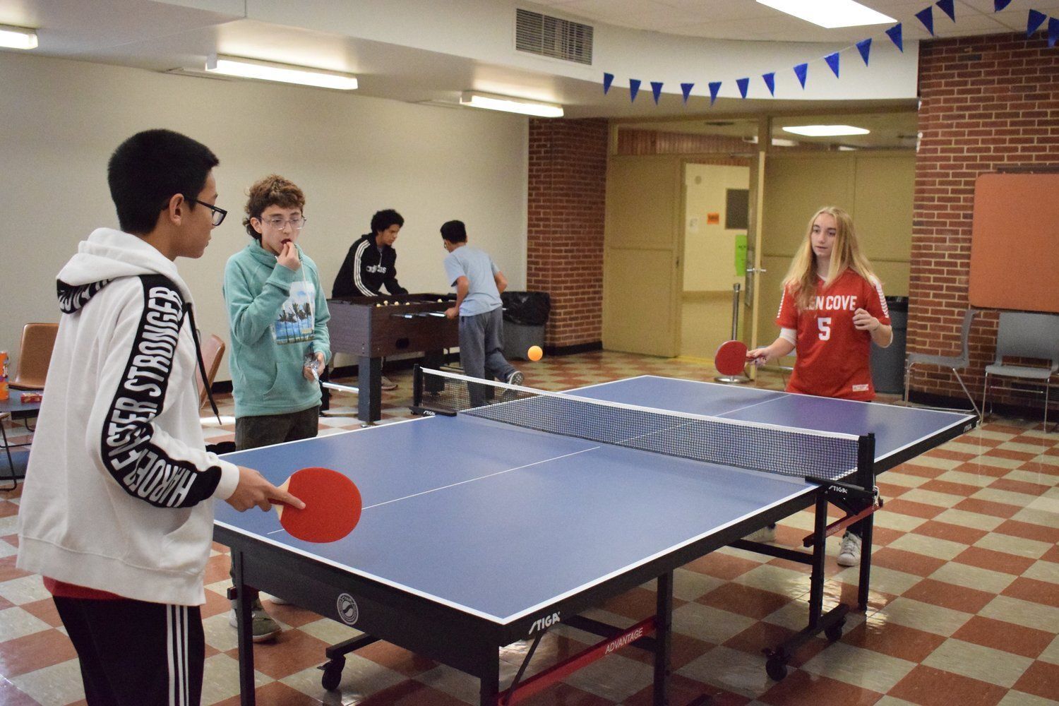 photo of kids playing ping pong