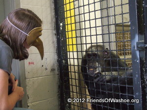 A caregiver plays a mask game with Tatu
