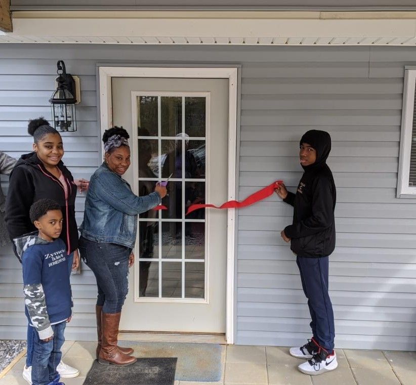 Habitat homeowner cuts ribbon on new home with her three children
