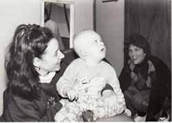 Baby Jack being held by a woman.