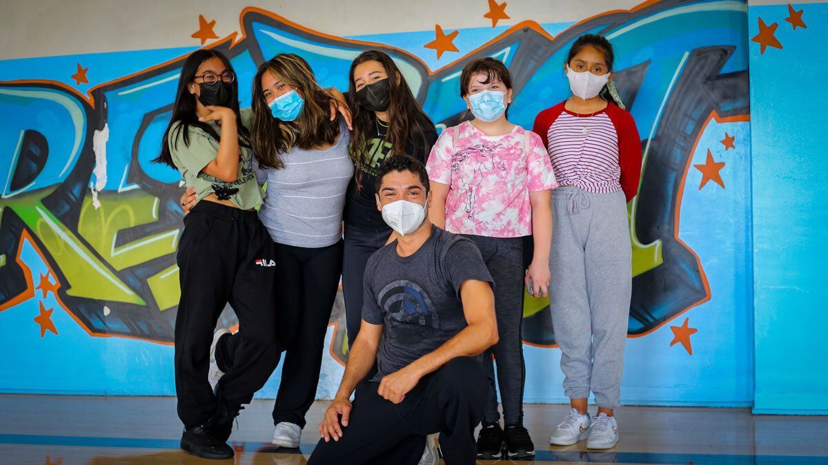 Group of students pose with dance instructor.