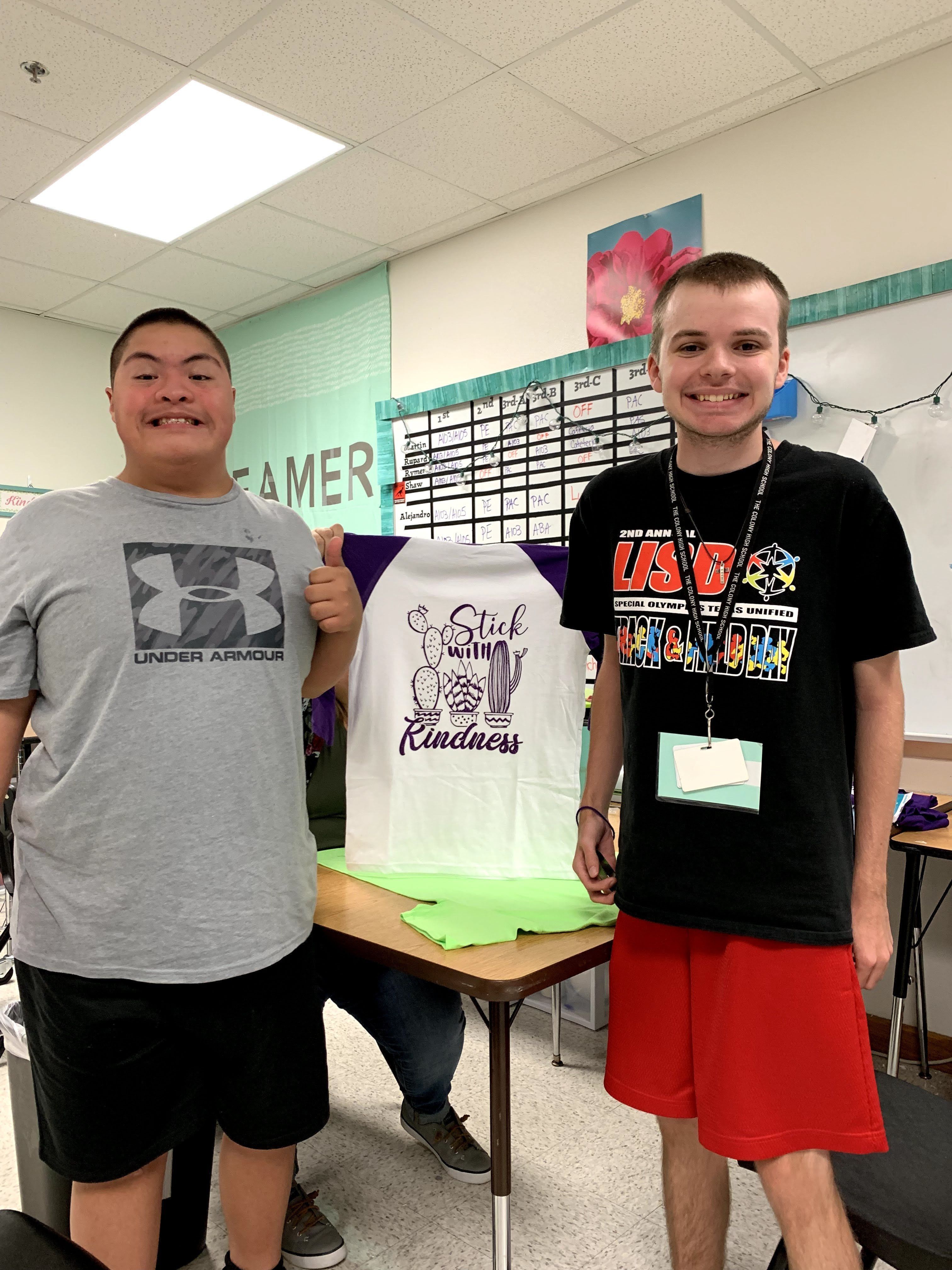 Two Life Skills Students at TCHS Posing with a T-Shirt They Printed