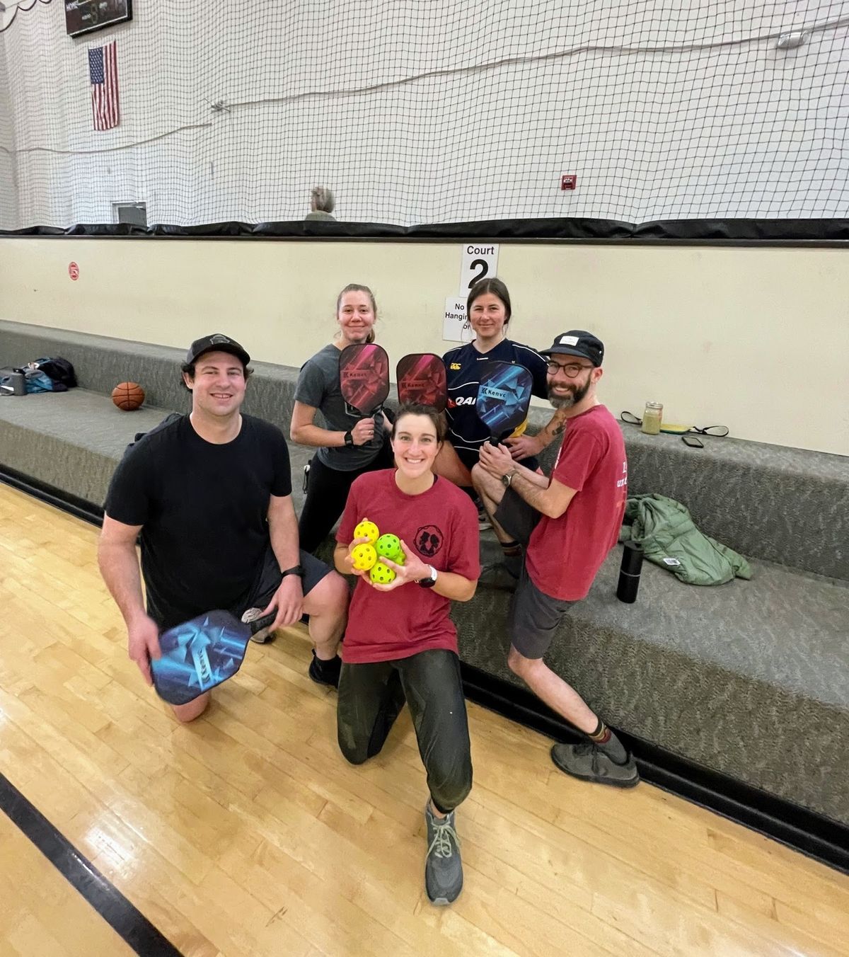 [Image Description: Northern Rockies staff members posing holding pickleball balls and rackets.]