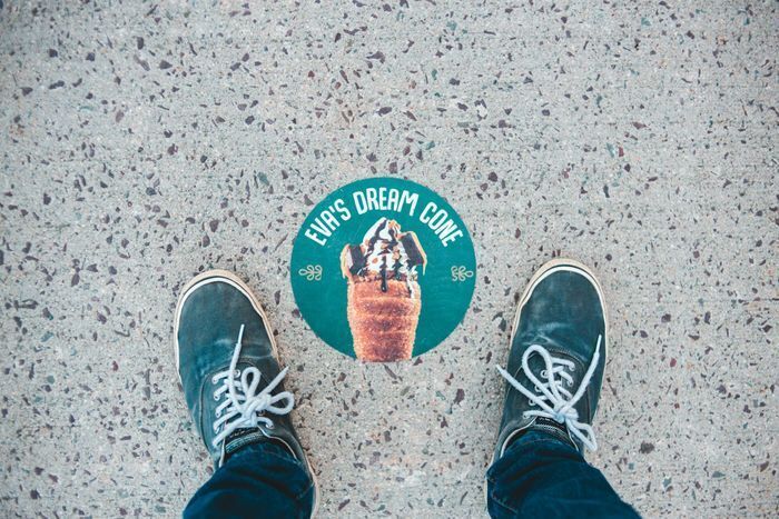 Instagrammable design floor decal for Eva's Dream Cone dessert shop, styled as a colorful sticker for playful social media photo ops.