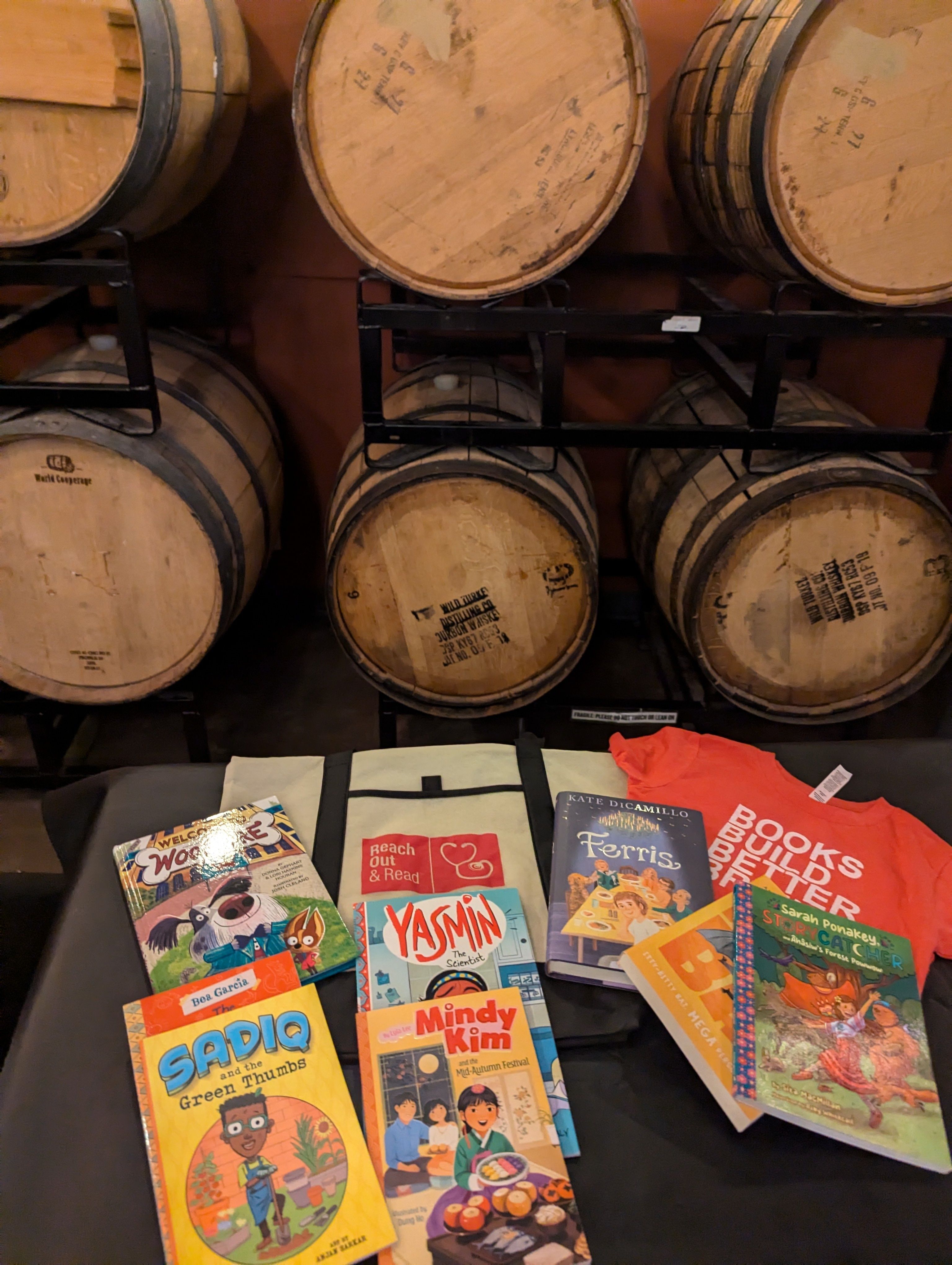 a display of chilren's books in front of several wooden barrels 