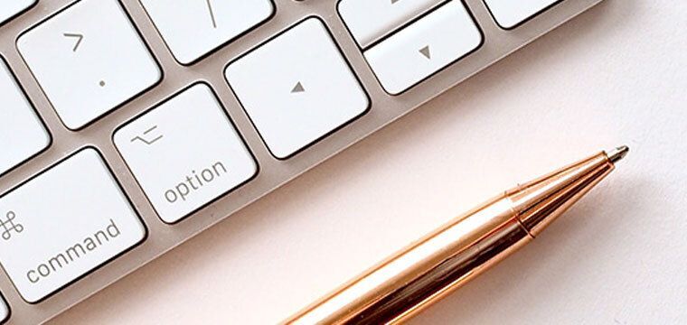 Pen and keyboard on a desk