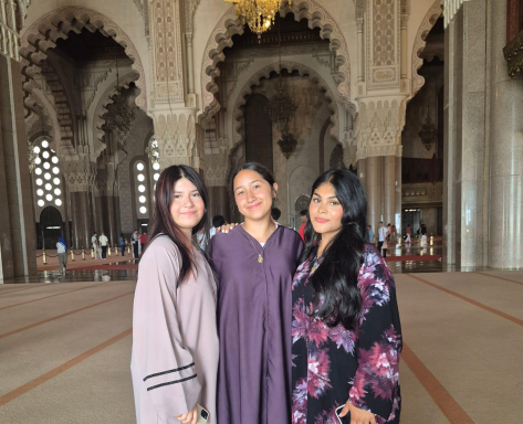 Isabella (pictured left) wearing traditional Moroccan clothing while visiting a temple.