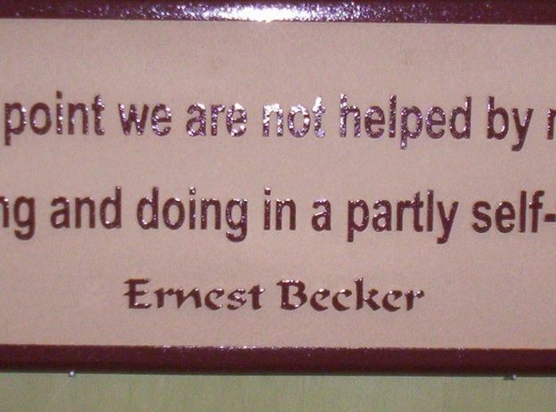 N23178 - Close-up of Carved Wall Plaque with Saying by Ernest Becker, Jewish-American cultural anthropologist and writer. 