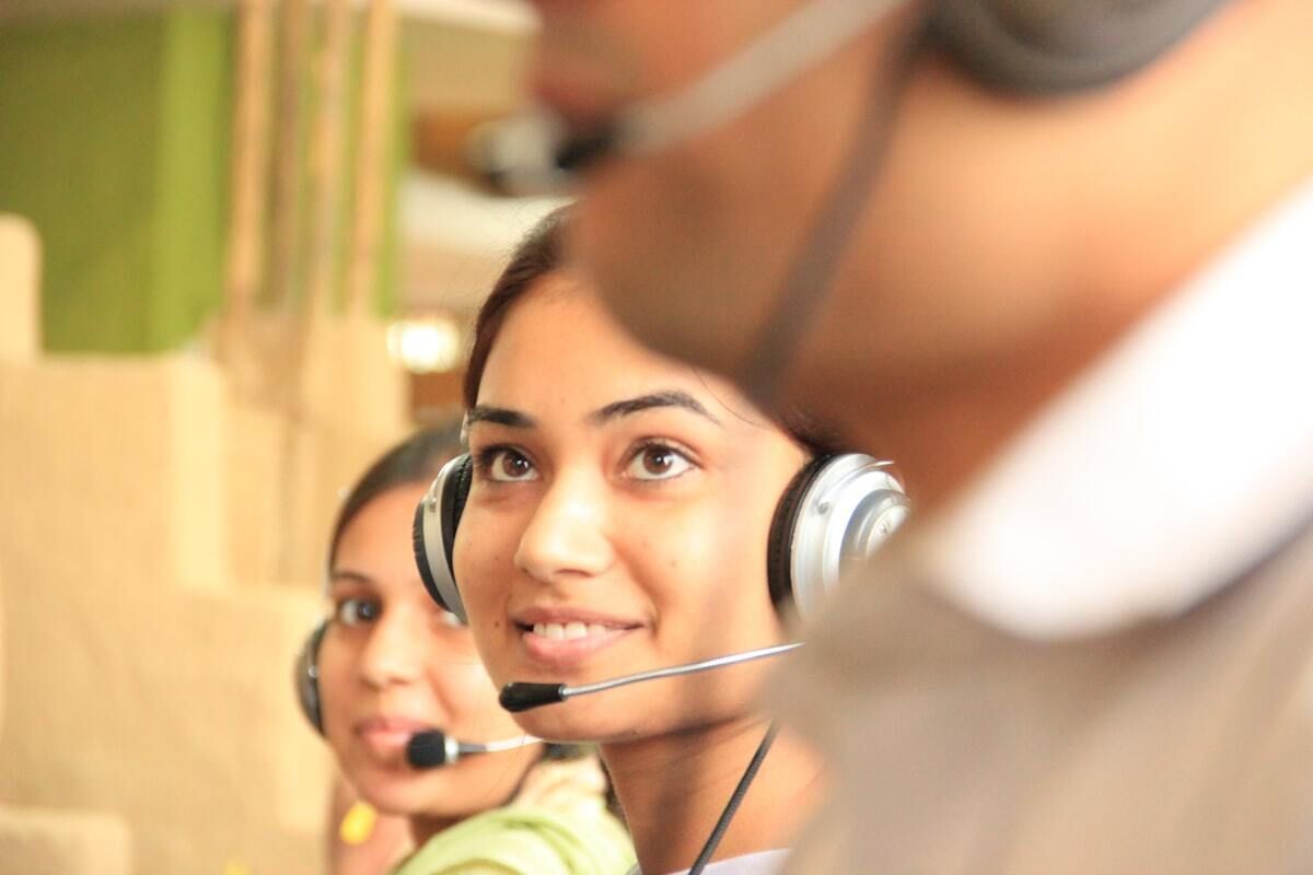 Three people with headsets on answering calls