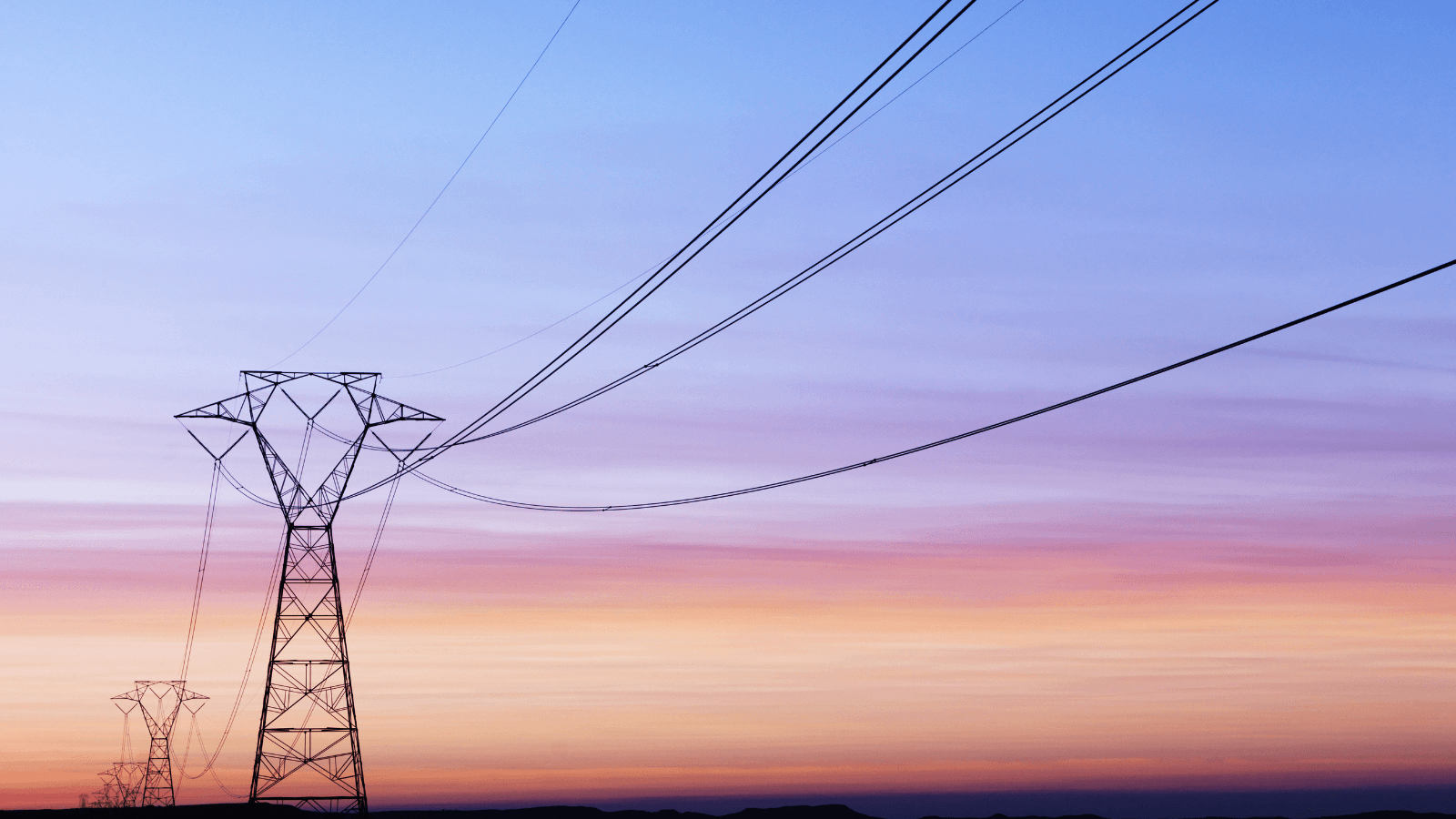 Power lines in front of violet sunset