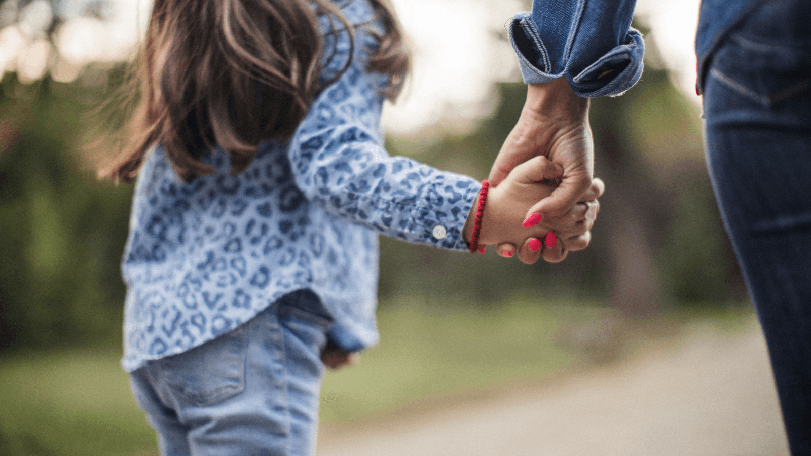 Mother and daughter holding hands