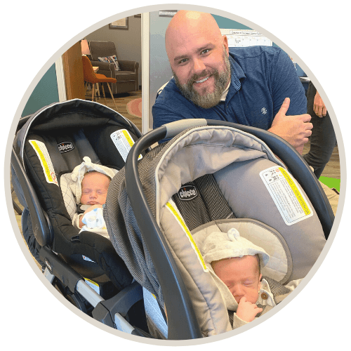 Dad and his twin babies in stroller.