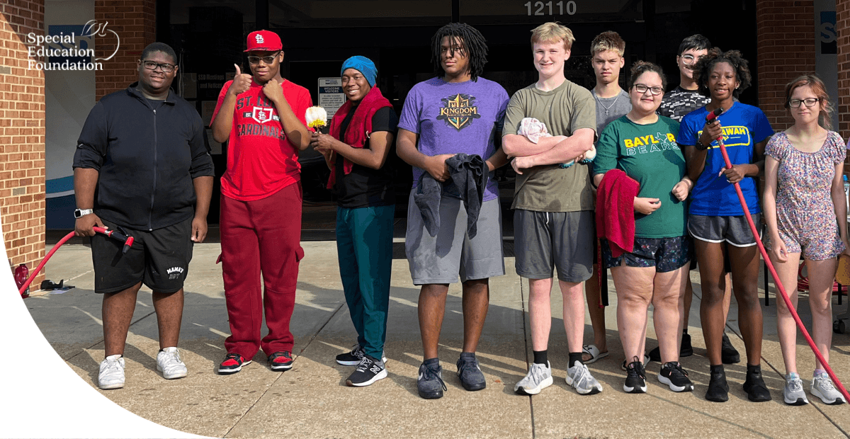 girls and boys holding hoses and sponges at a car wash