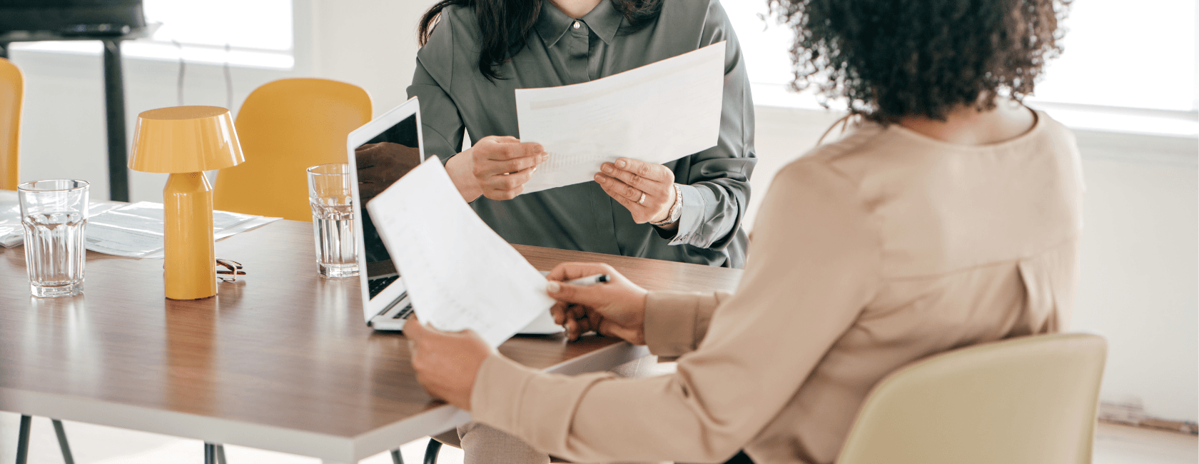 Two people looking at resumes together.