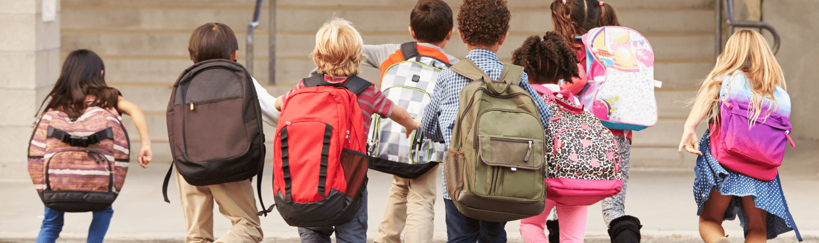Kids walking together with backpacks on