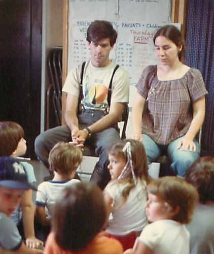 Lawrence Taft and carol Entin are seated in front of children