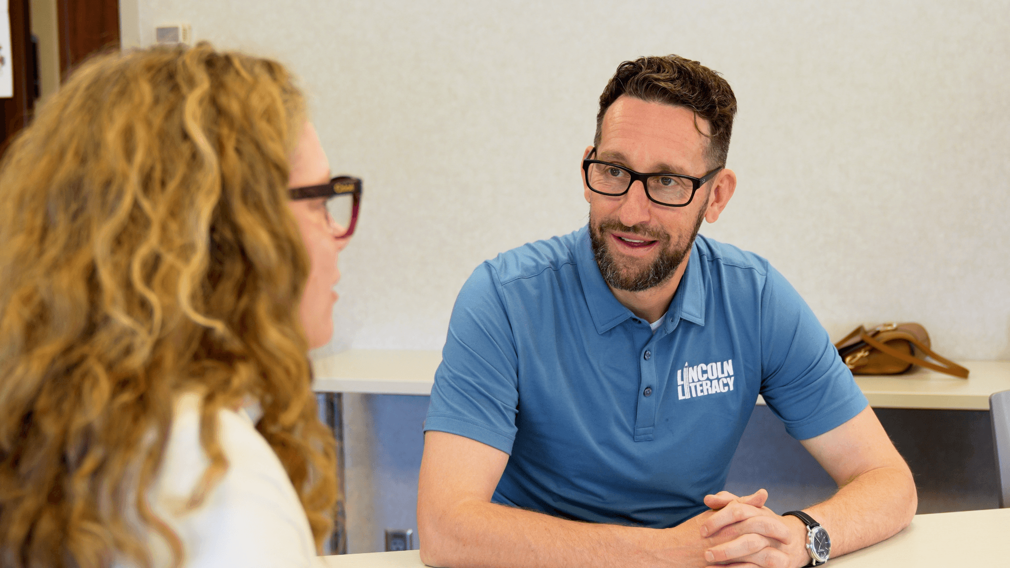 Lincoln Literacy Executive Director Bryan Seck talks with Bryan College of Health Sciences President Kelsi Anderson in a college classroom
