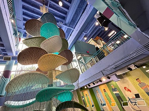 Large towering, plant-like structure made of rope for kids to climb.