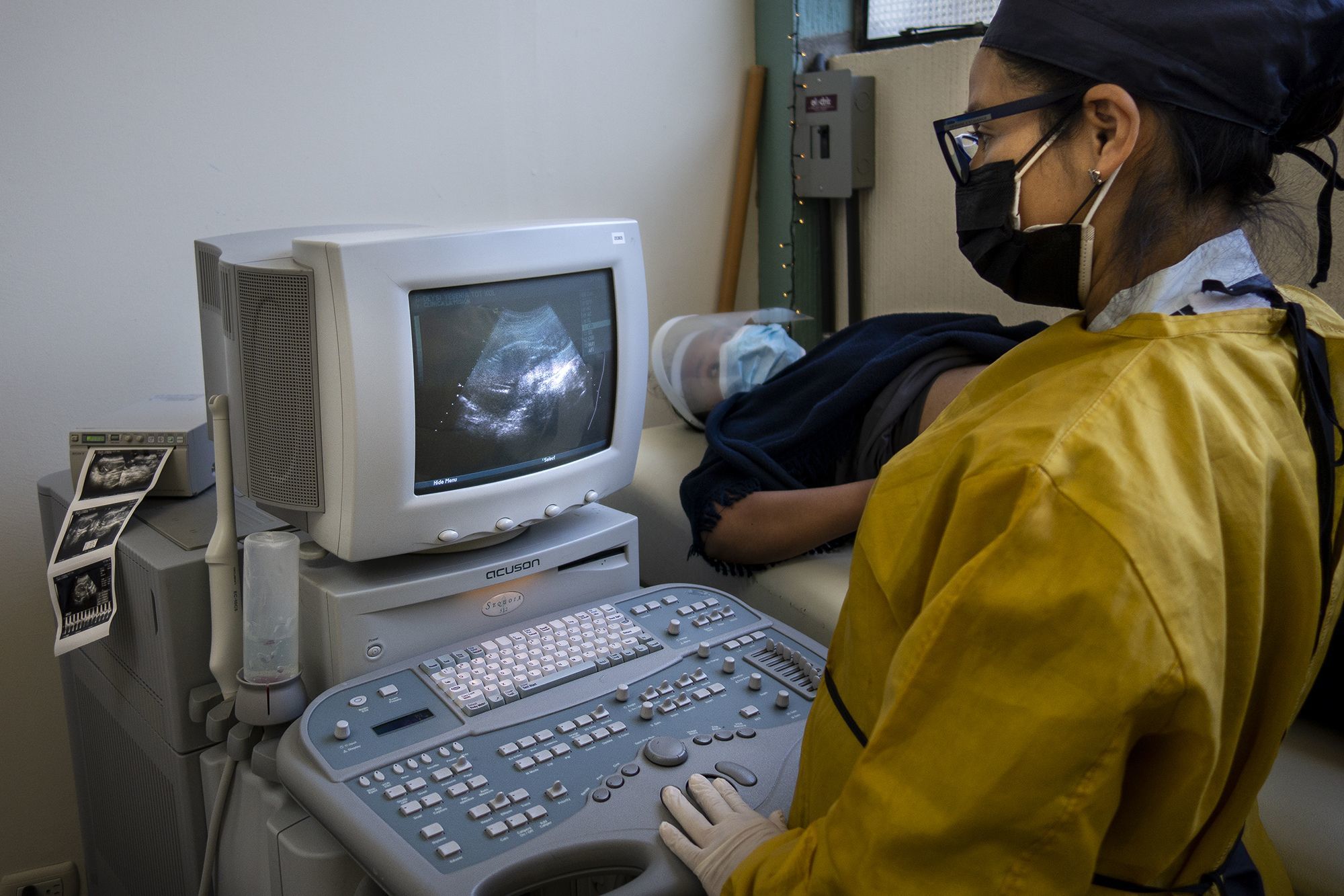 Dr. Lidia performs an ultrasound on a clinic patient.