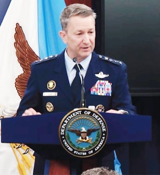 Department of Defense Press Briefing Seal – A prominently displayed Department of Defense emblem on a podium, set against military flags, symbolizing official communication from senior leadership within the U.S. Armed Forces.