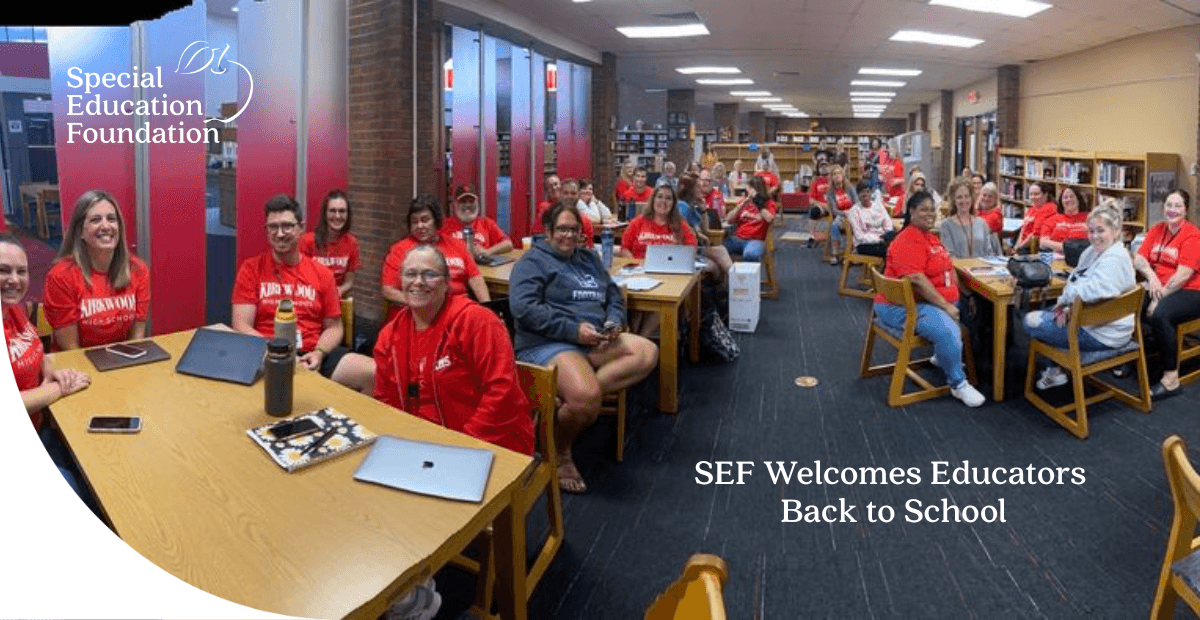 group of teachers sitting in chairs in a library