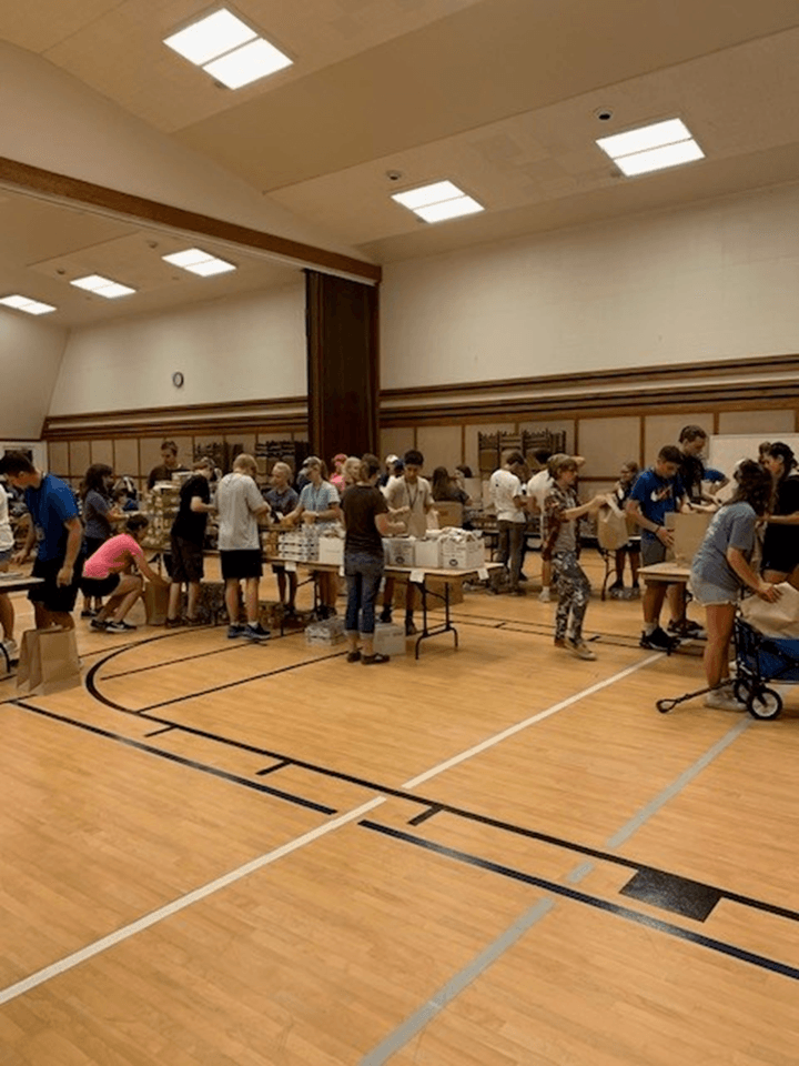 Students putting together emergency food kits