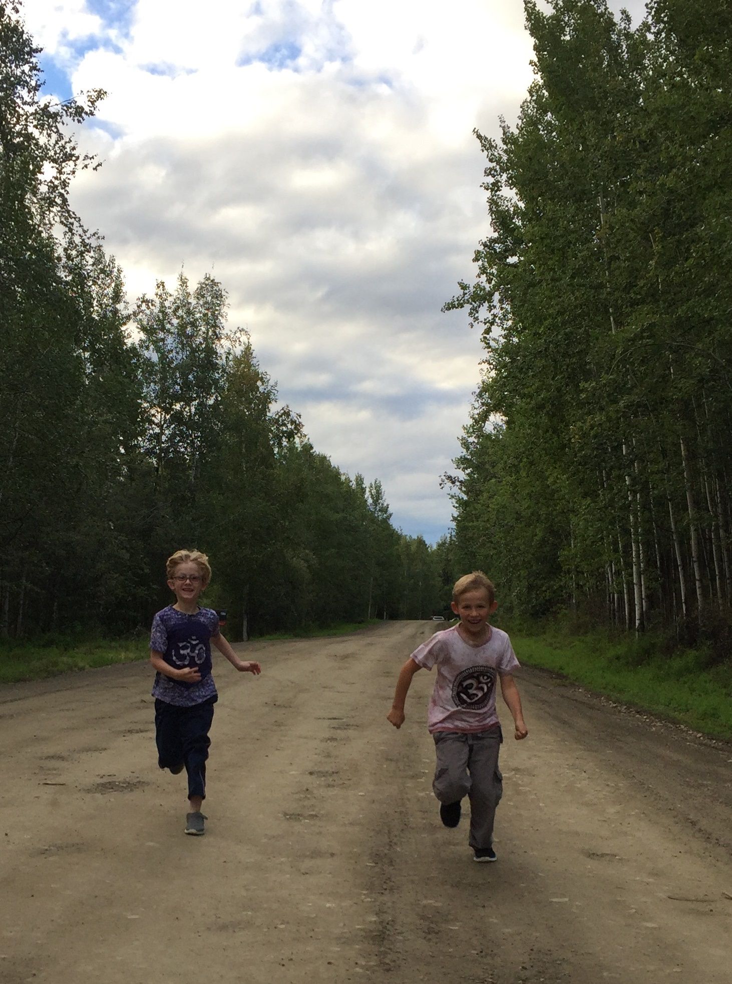 Caroline Brown's sons Galen and David running down a dirt road.