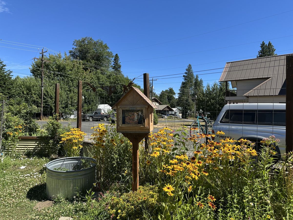 An image of a little free library filled with garden books at the garden.