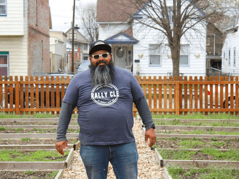 Luis Luna standing in between garden boxes outside