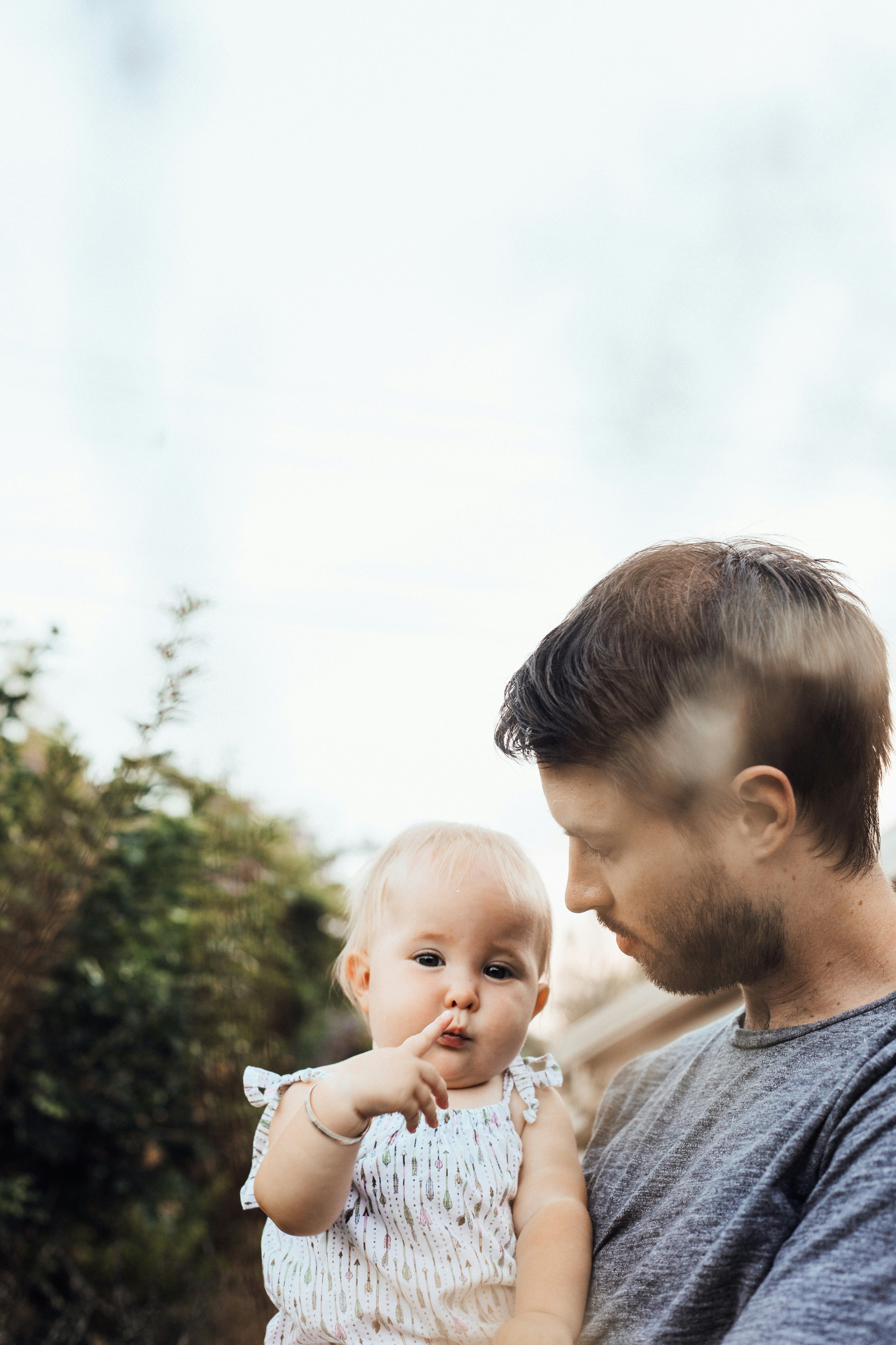 Child holding their parents' hands.