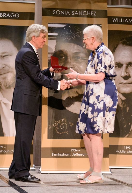 Dean Louis Pitschmann presents Mary Lou Meaher with the Augusta Jane Evans Wilson medal.