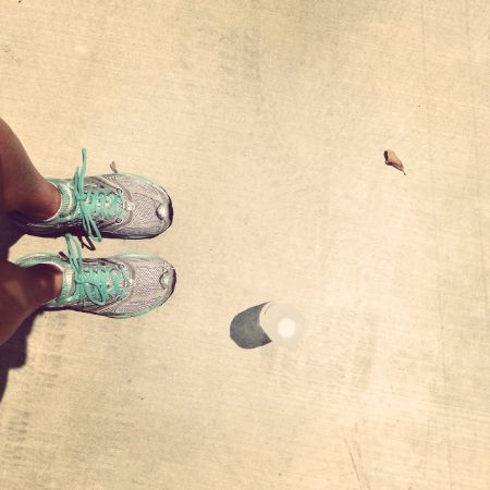 Photo from Elise's Instagram showing her sneakered feet and a bottle of water from a top view.