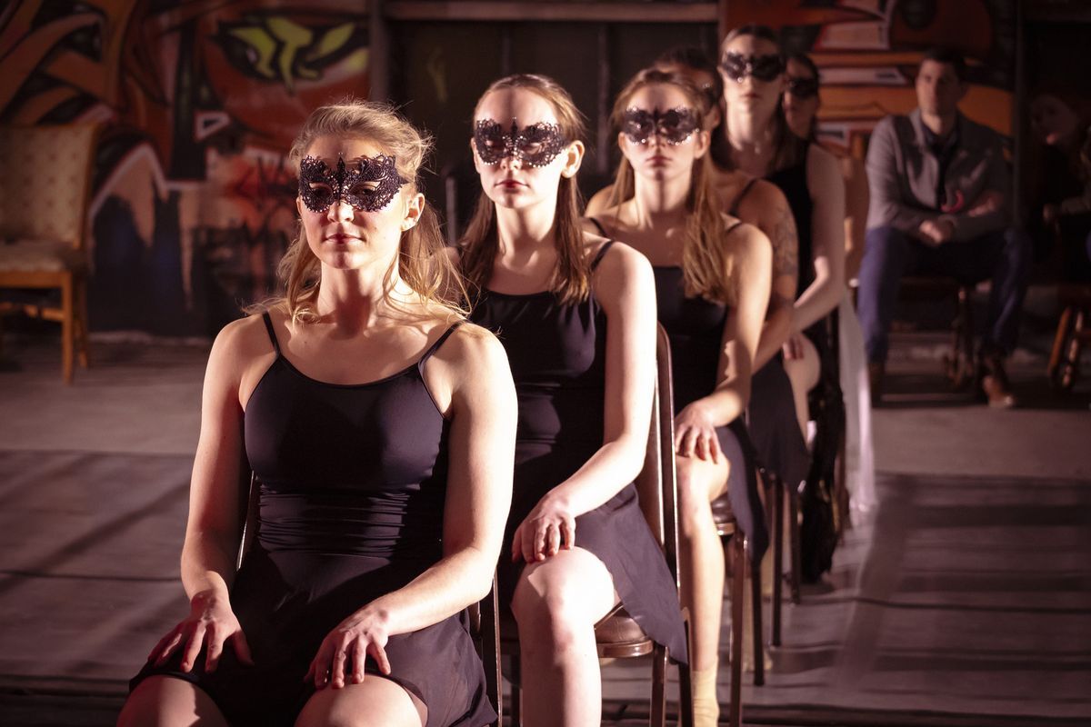 A Line of Woman Dancers Wearing Masks