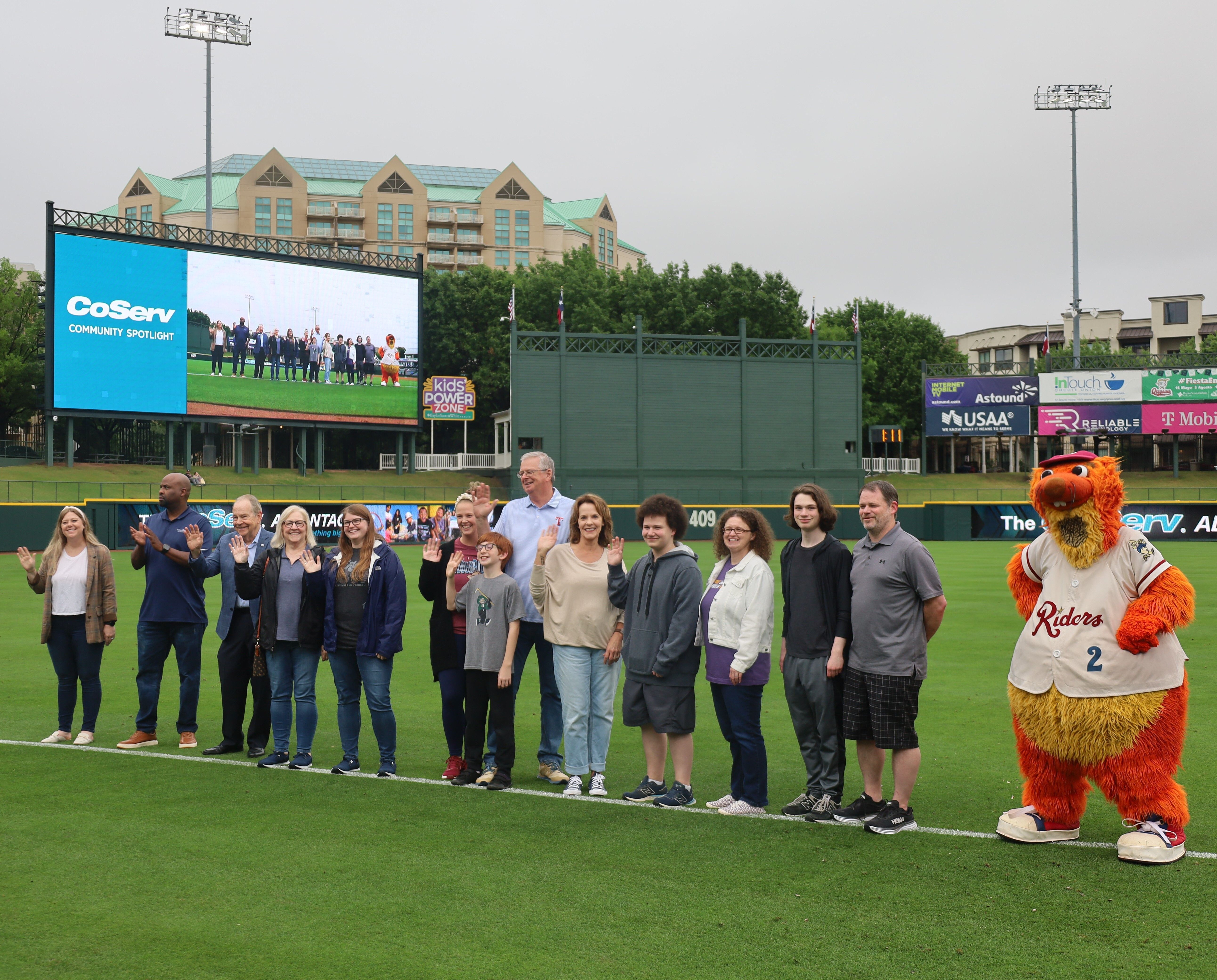 LEF and Coserv team members pose for a group photo on the mound at the Frisco Rough Riders field