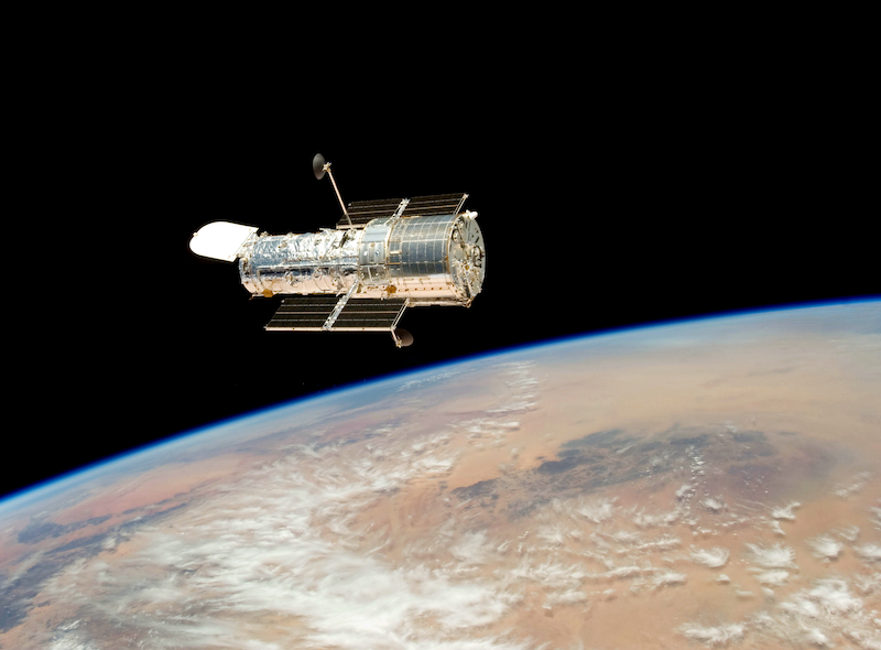 In this photo from the Space Shuttle Atlantis crew in 2009, the Hubble Space Telescope appears to float above Earth. 