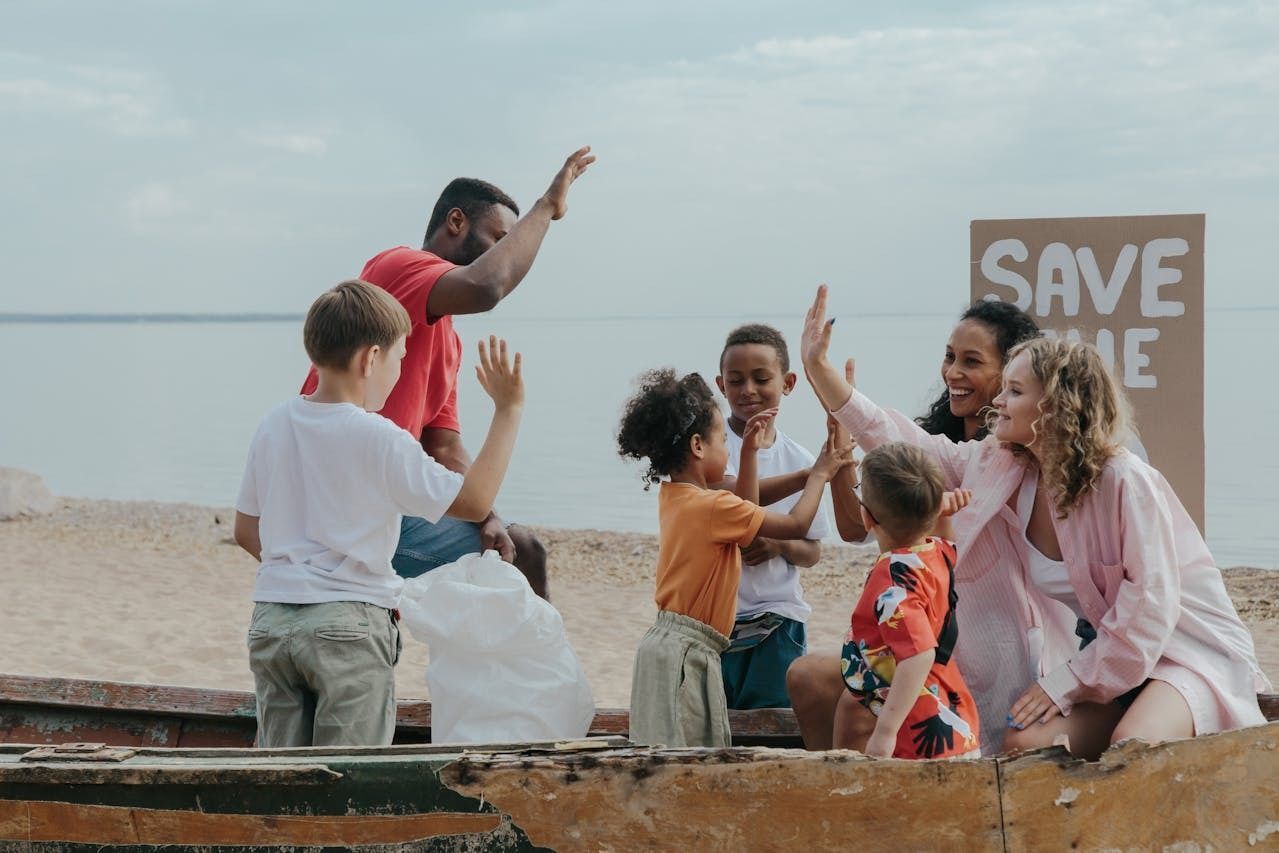 Group of People High Fiving at beach cleanup. 
