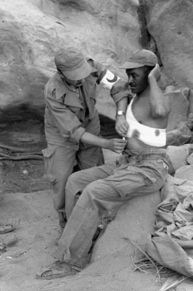 Red Crescent Worker Bandaging Wounded Soldier
