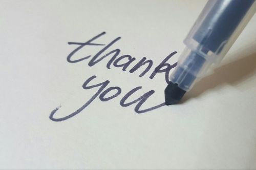 A pen writing "thank you"