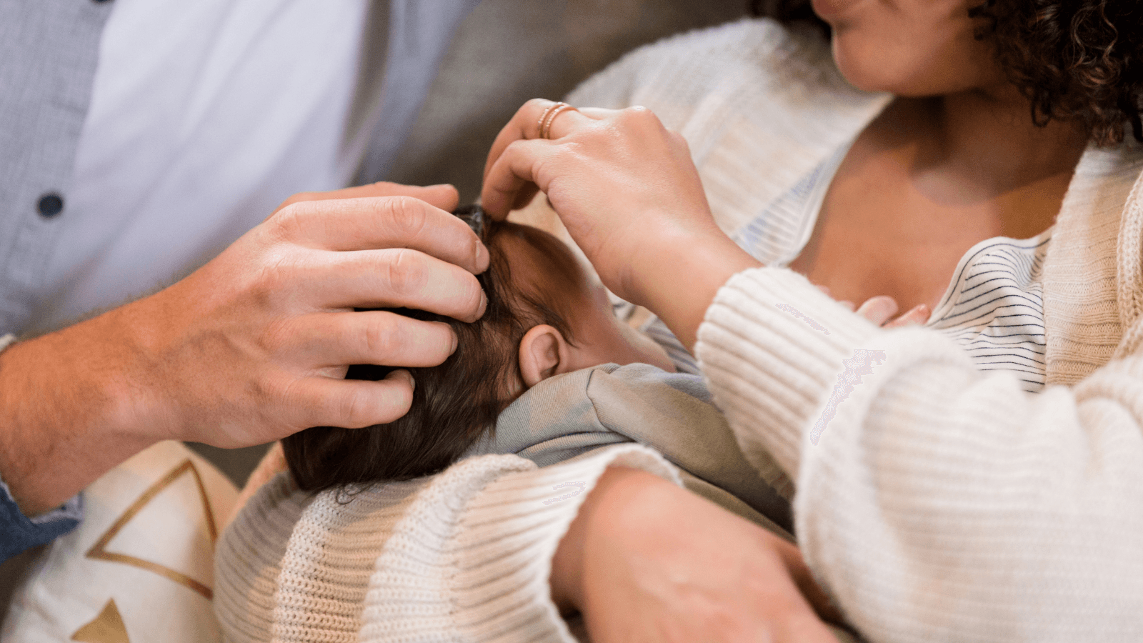 Parents holding infant against chest