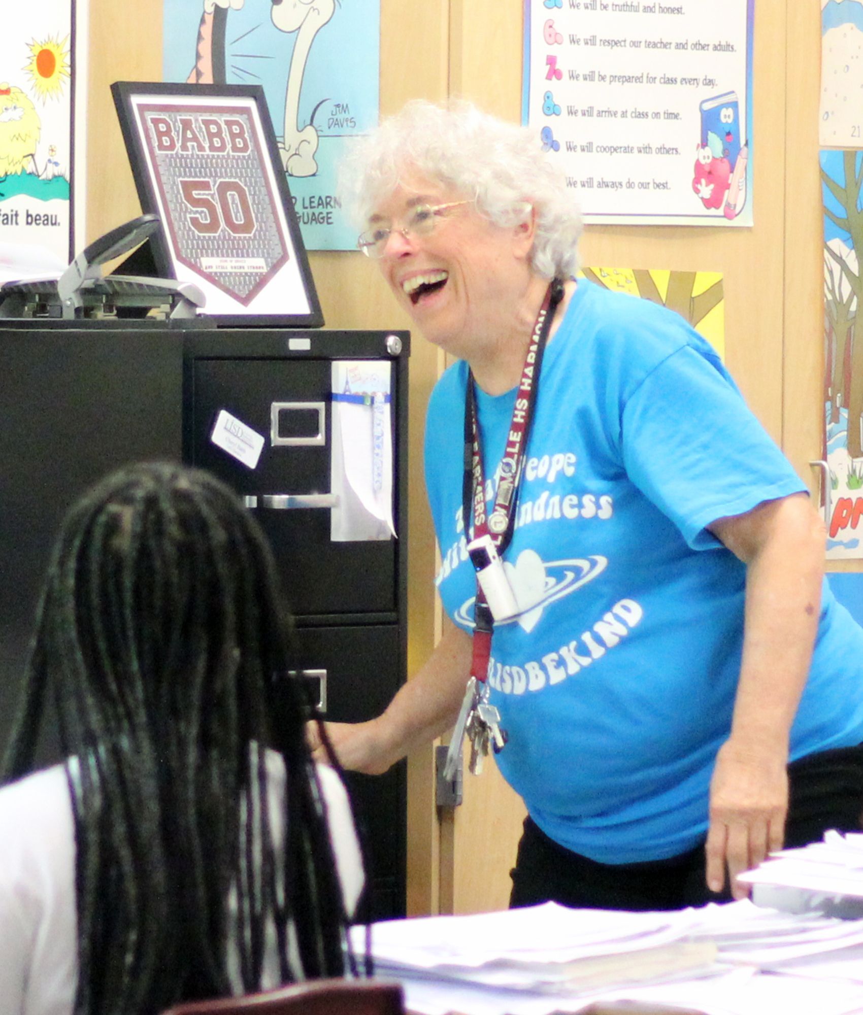 Cheryl Babb smiling widely after being surprised with the 2022 Ted Barnes Award check.