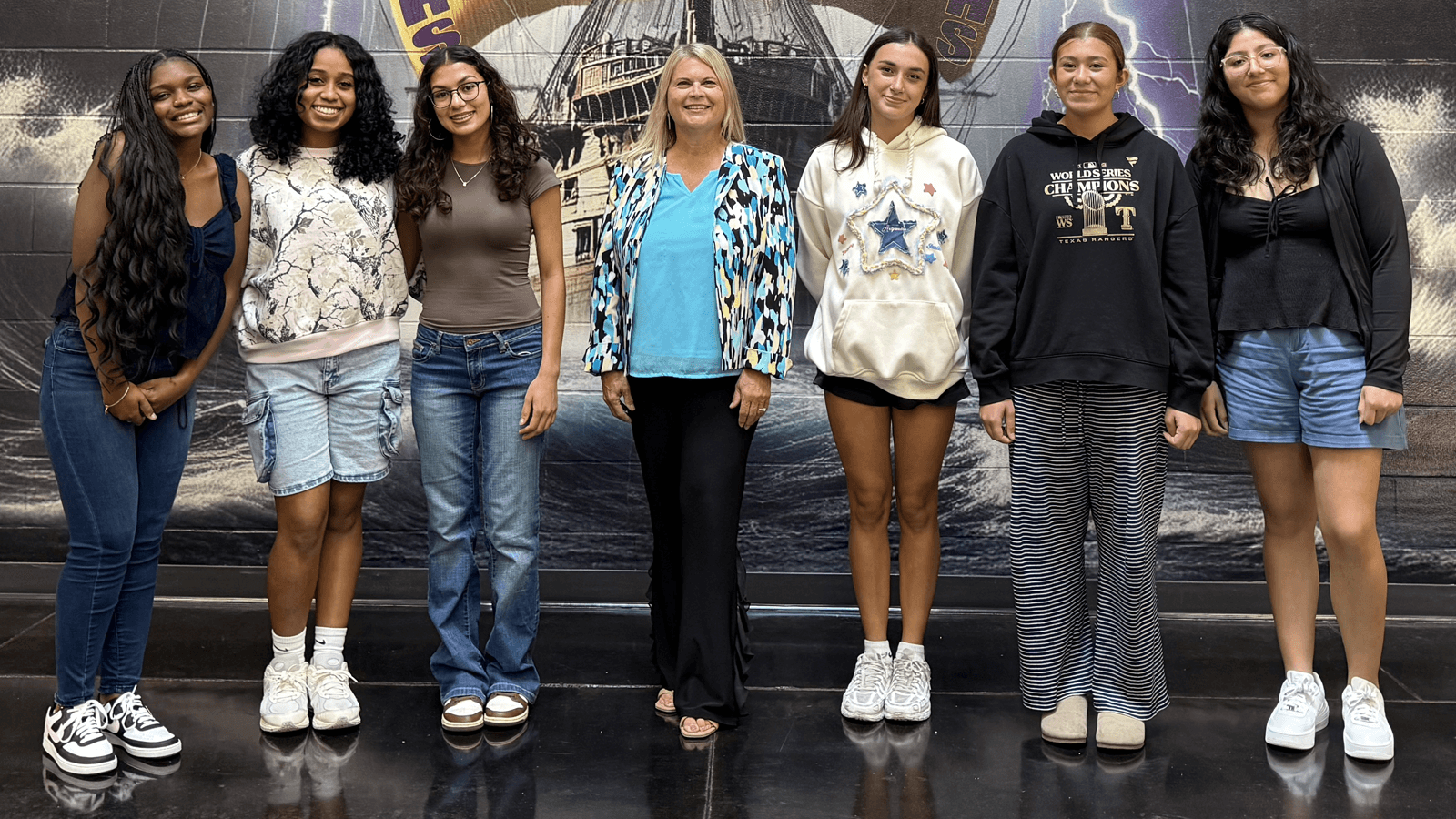 students posing with funder