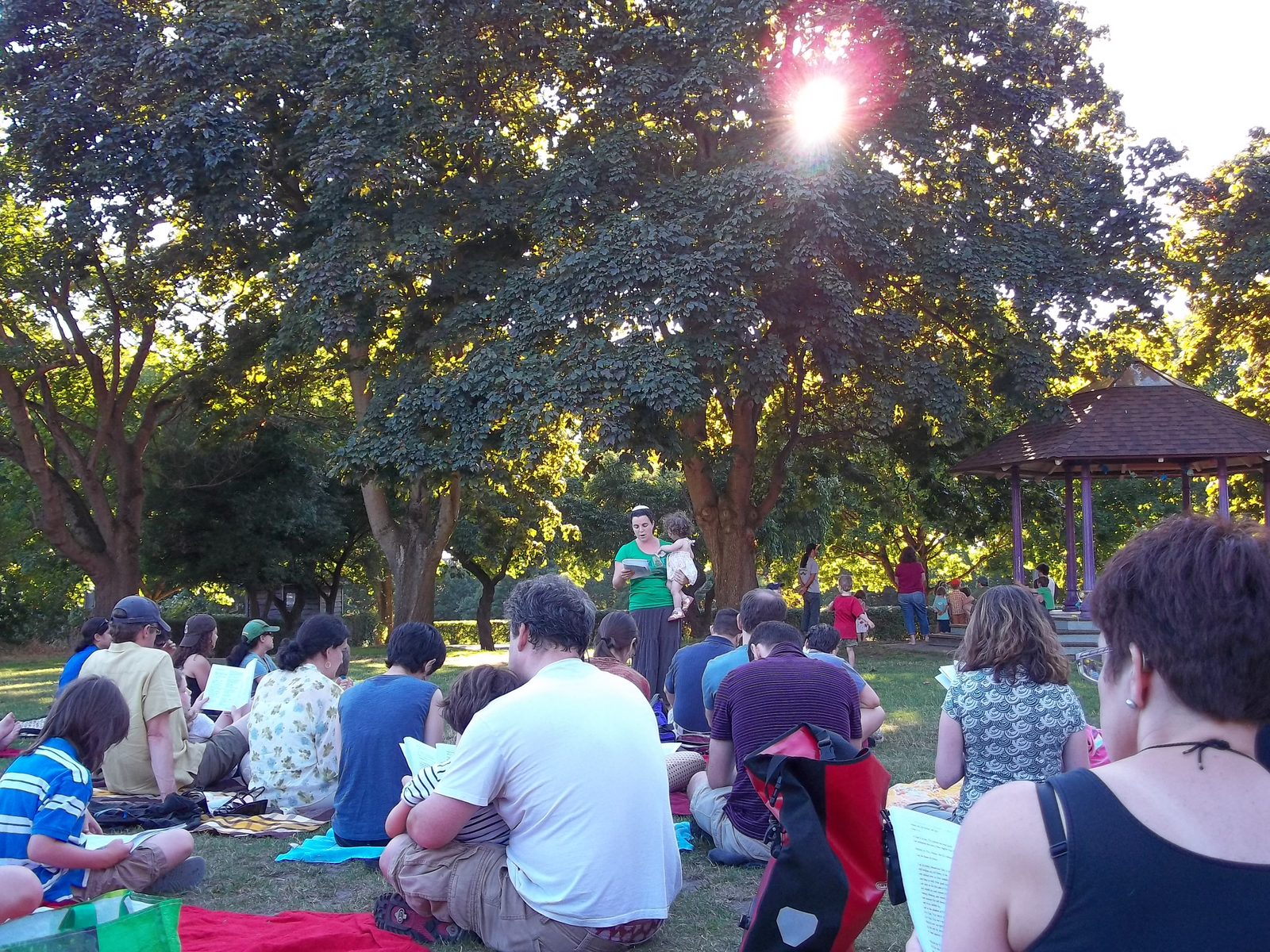 Rabbi Nussbaum leading a Shabbat service in the park.