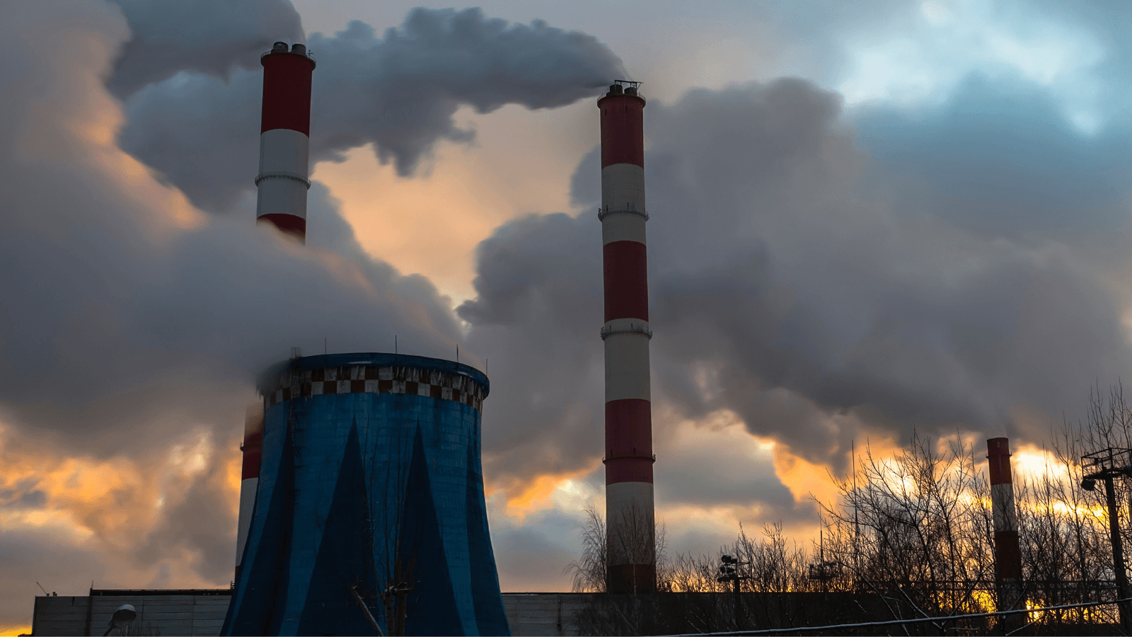 smoke coming from a power plant during sunset