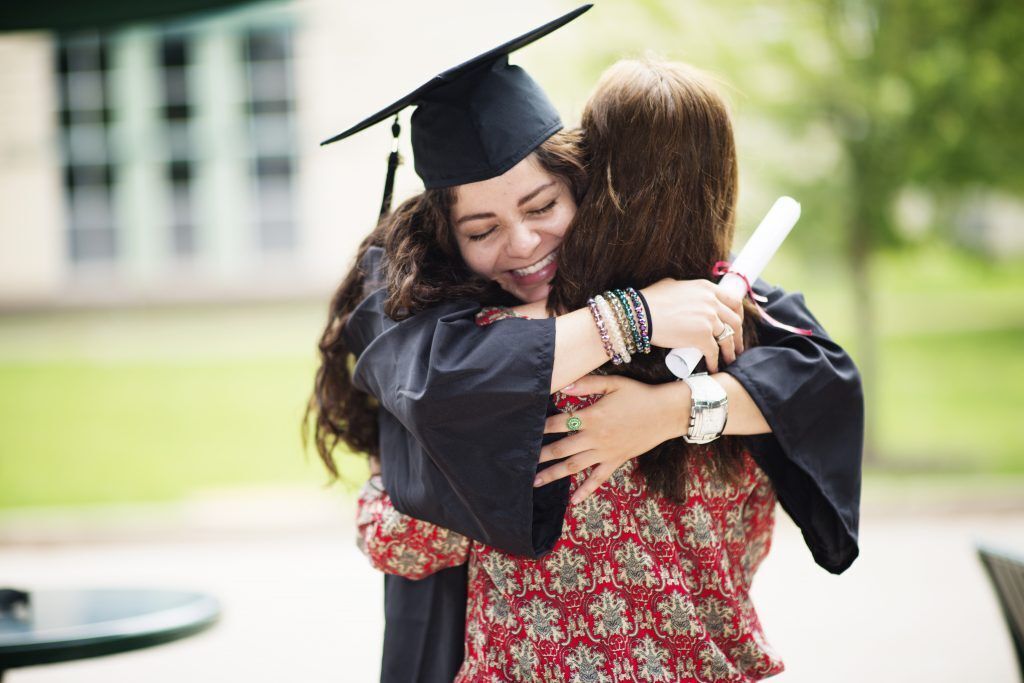 Graduate hugging her mother.