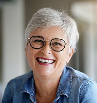Older woman smiling in denim shirt