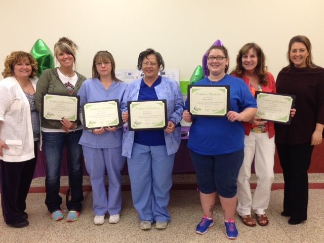 People smiling with awards.